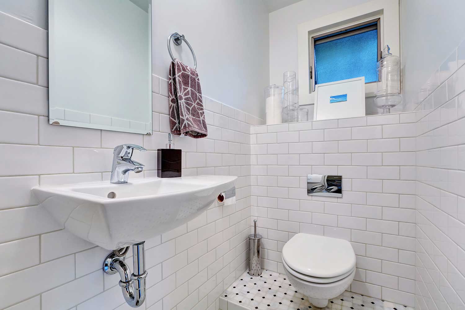 White half bathroom interior with tile wall trim