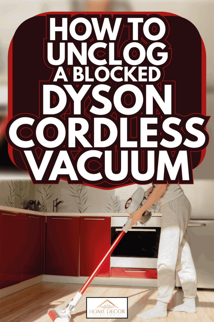 woman cleaning kitchen with red cordless vacuum. How To Unclog A Blocked Dyson Cordless Vacuum