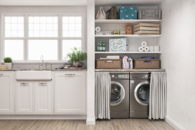 A minimalist inspired laundry room with white walls and gray washing machine and dryer, Washer And Dryer Dimensions: How Big Are They Typically?