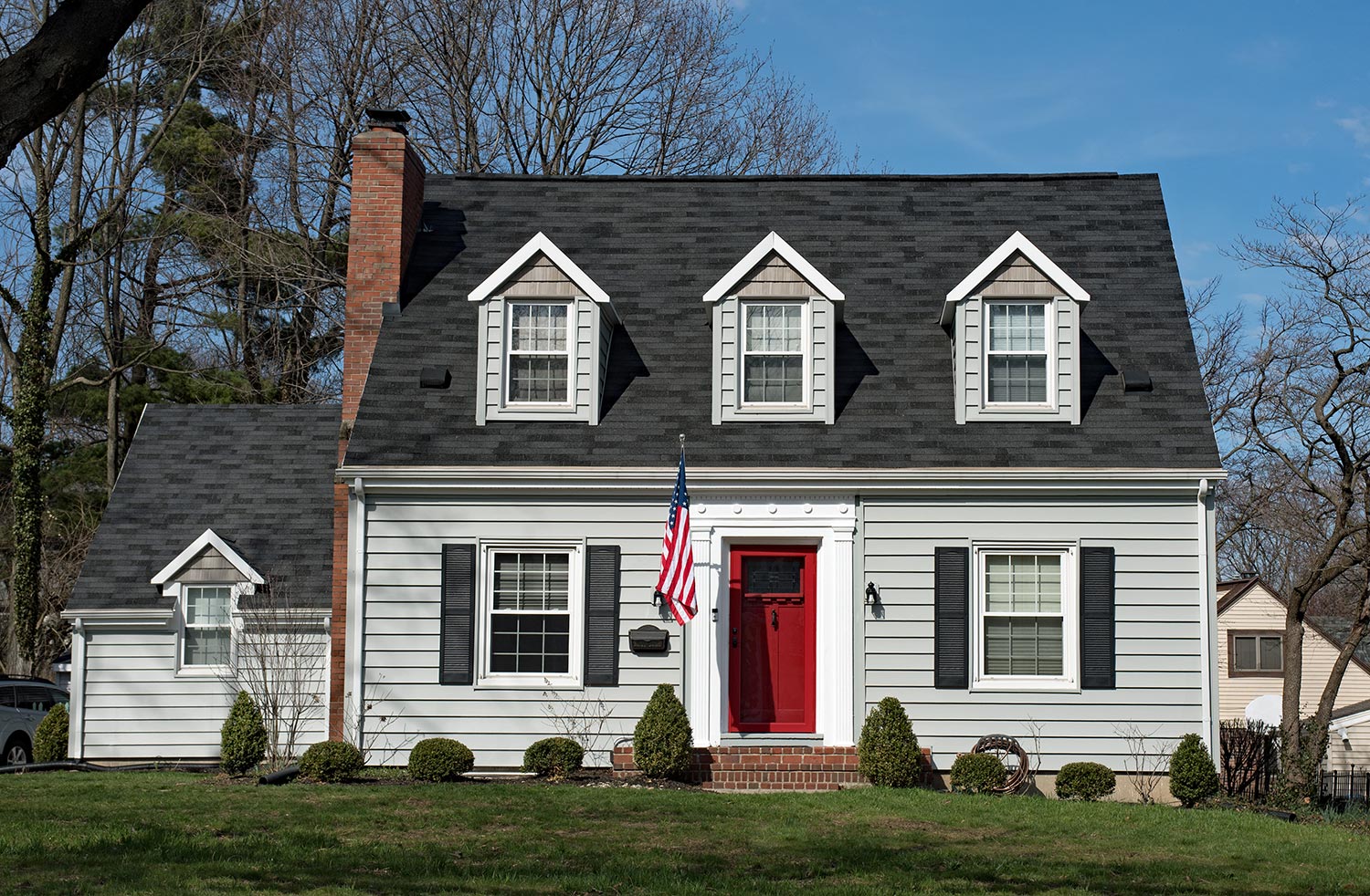 Cape cod house with three dormers & red door