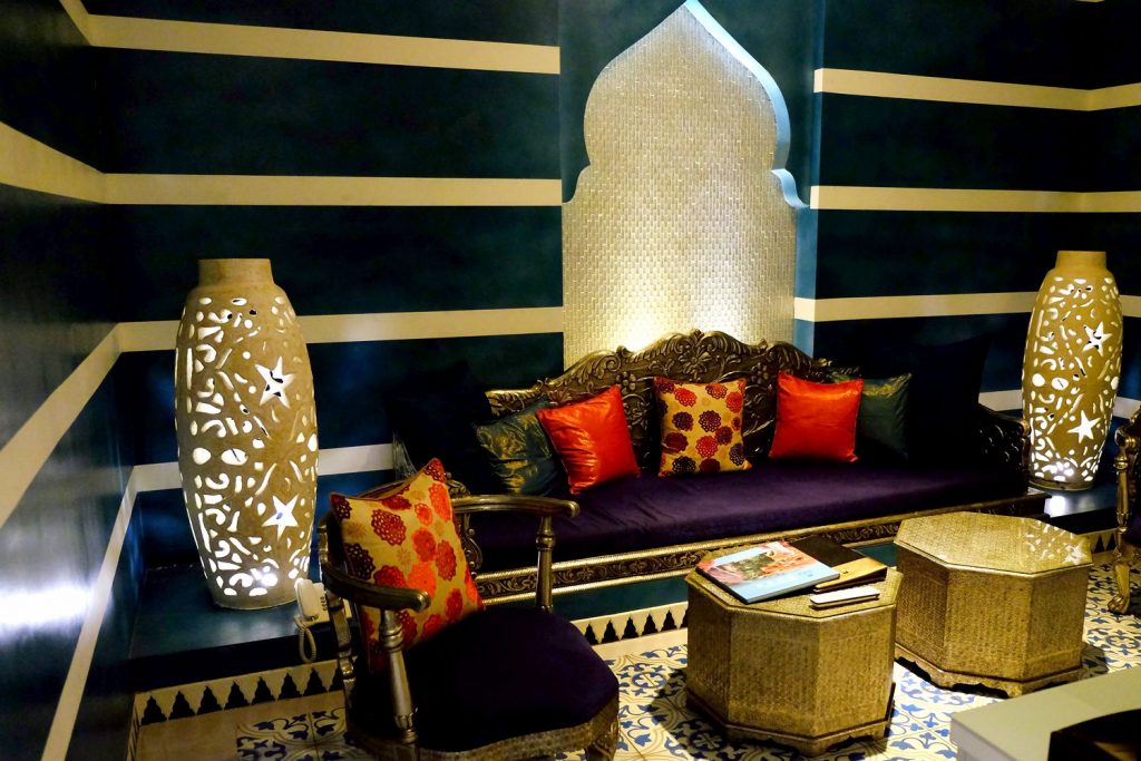 Moroccan inspired bedroom with glowing vasess and ogee patterned tile flooring