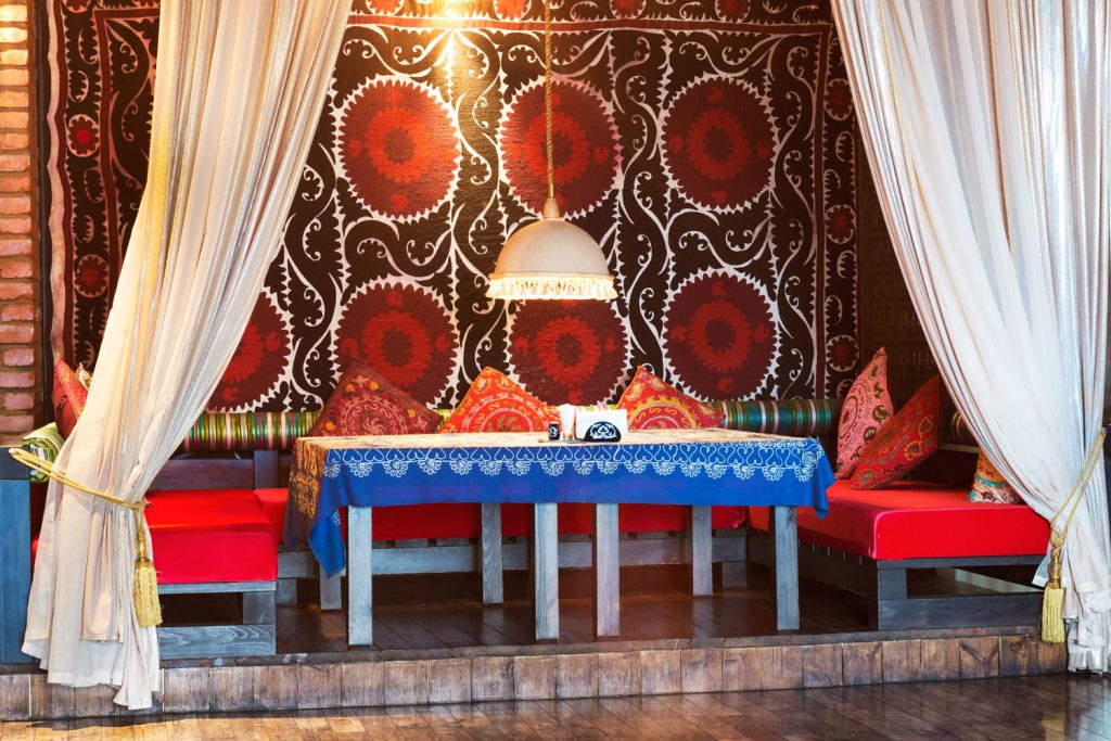 Moroccan restaurant dining area consisting of curtains and a dangling lamp