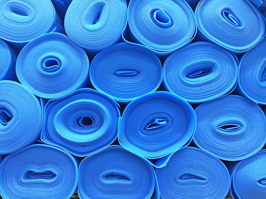 Stacked blue flooring underlay rolls