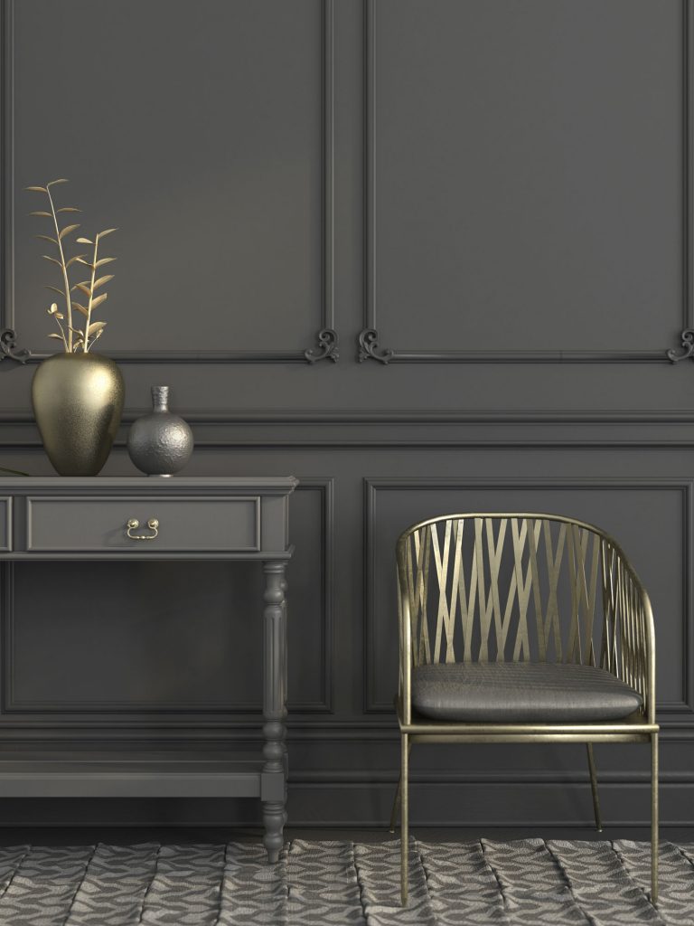 Stylish gray interior with a focus on the golden chair and the vase with a gold branch