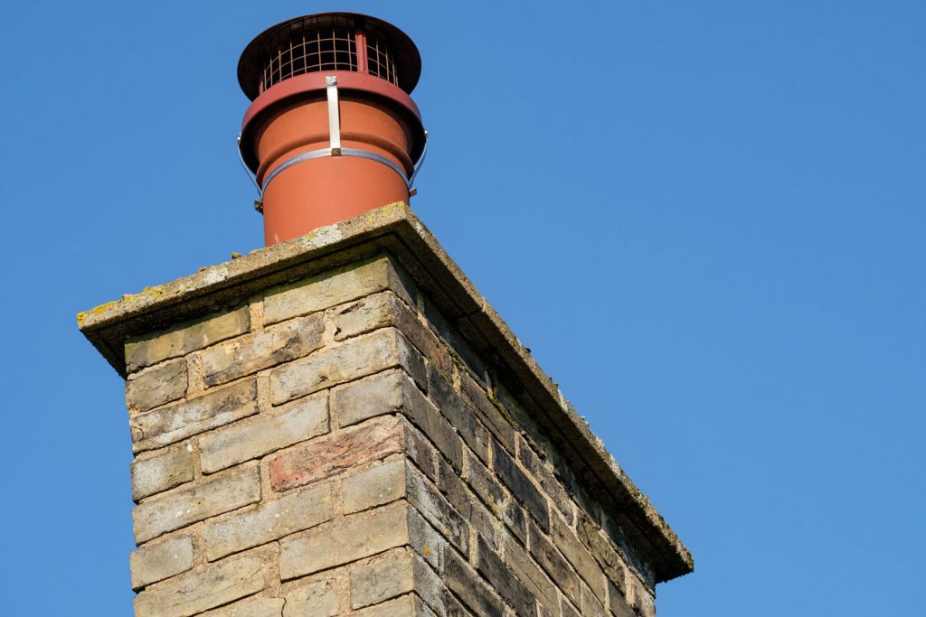 The cap on the chimney prevents birds from nesting in the smoke stac
