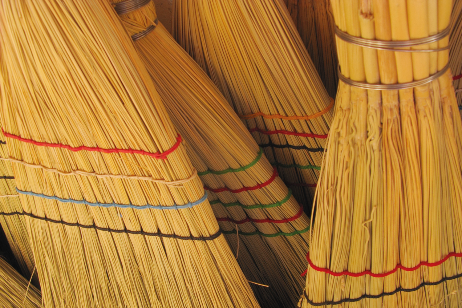group of long handled brooms commonly used with a dustpan