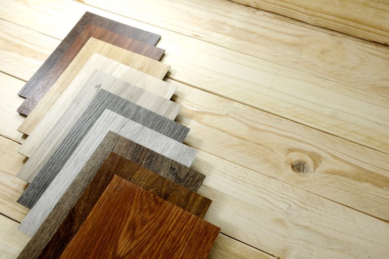 wood texture floor Samples of laminate and vinyl floor tile on oak wooden Background for new construction or renovate building or home renovate, Can You Put Laminate Flooring Over Carpet?