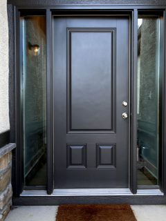 A black pivot door with glass panes on the sides, What Does A Black Front Door Mean?