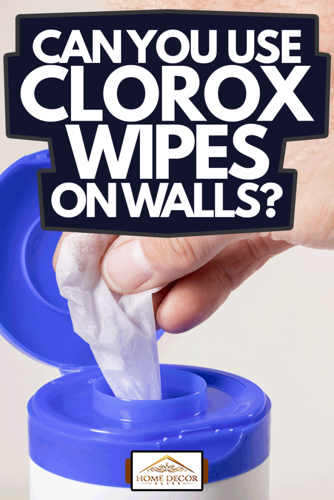 White wipes soaked in disinfectant pulled out by a male's hand, Can You Use Clorox Wipes On Walls?