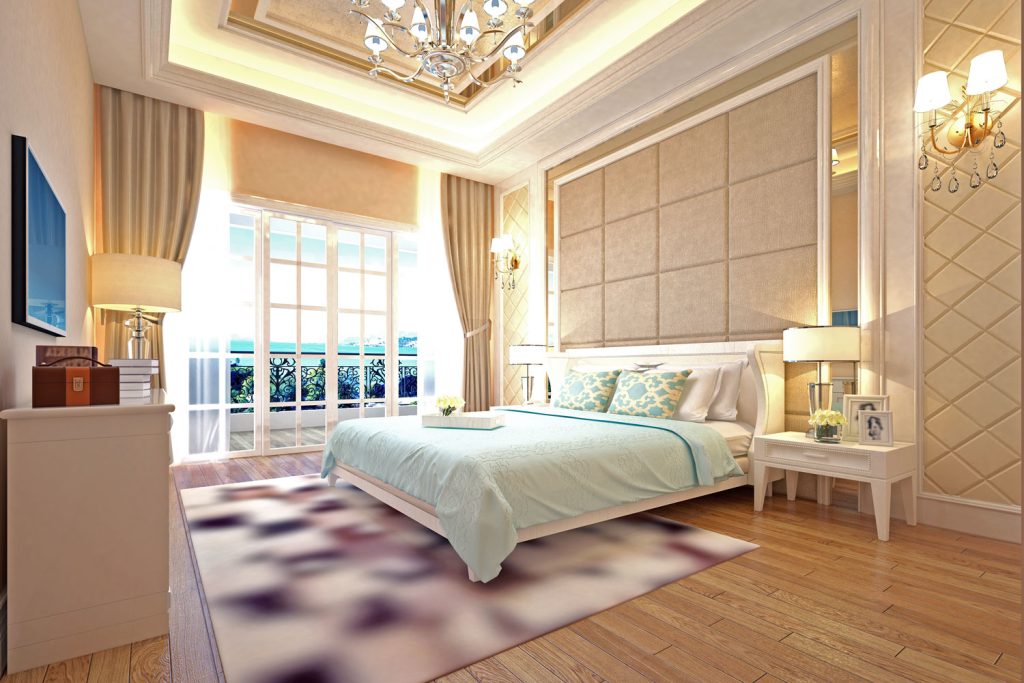 Gold inspired bedroom designed with gold curtains and wooden flooring