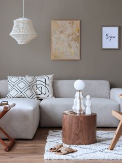 Interior of a stylish home decor with white modular sofas, rattan chairs and gray painted walls, What Color Walls Go With A Tan Couch?
