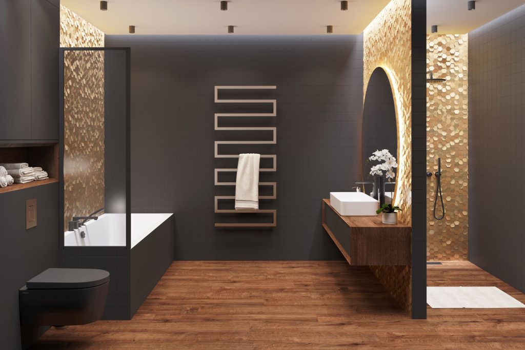 Interior of an ultra luxurious bathroom with wooden flooring, gold planted backsplash and black accent wall