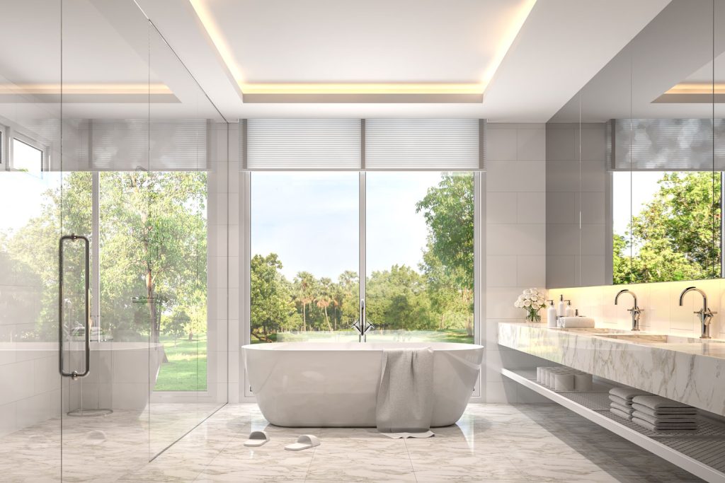 Luxurious contemporary bathroom with glass shower walls and a marble vanity