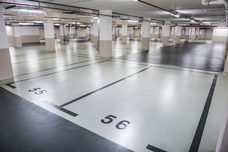 A marked parking spot in underground garage, How Big Is An Average Parking Space?