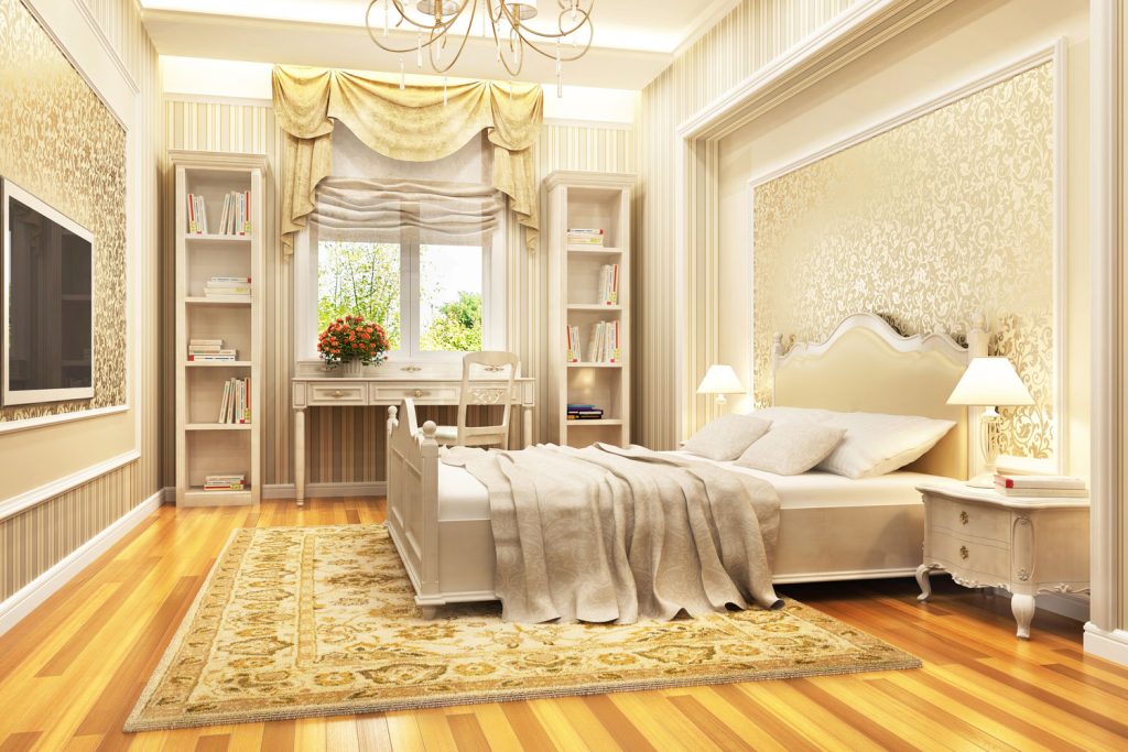 Modern luxurious bedroom with wooden flooring, luxurious elegant beddings and gold curtains