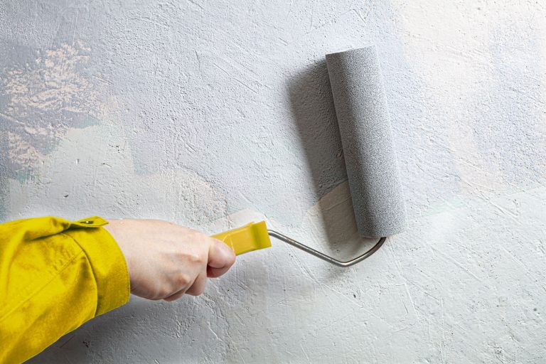 Painter applying gray paint on the curved wall, How To Paint A Curved Wall