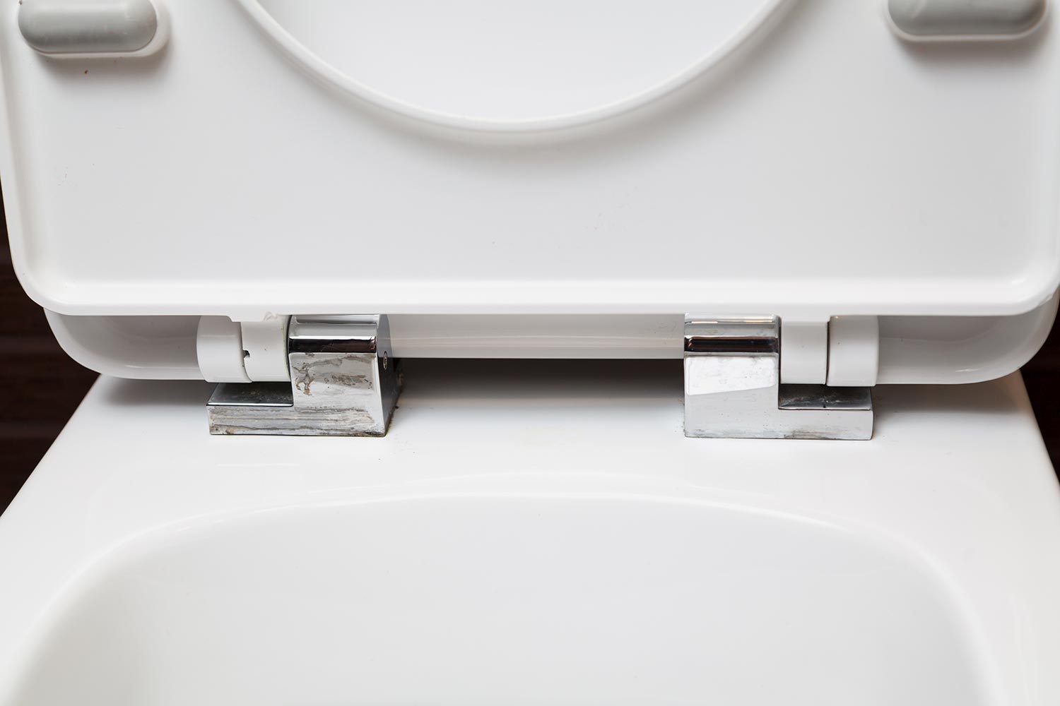 Seat and lid attachment system on modern toilet