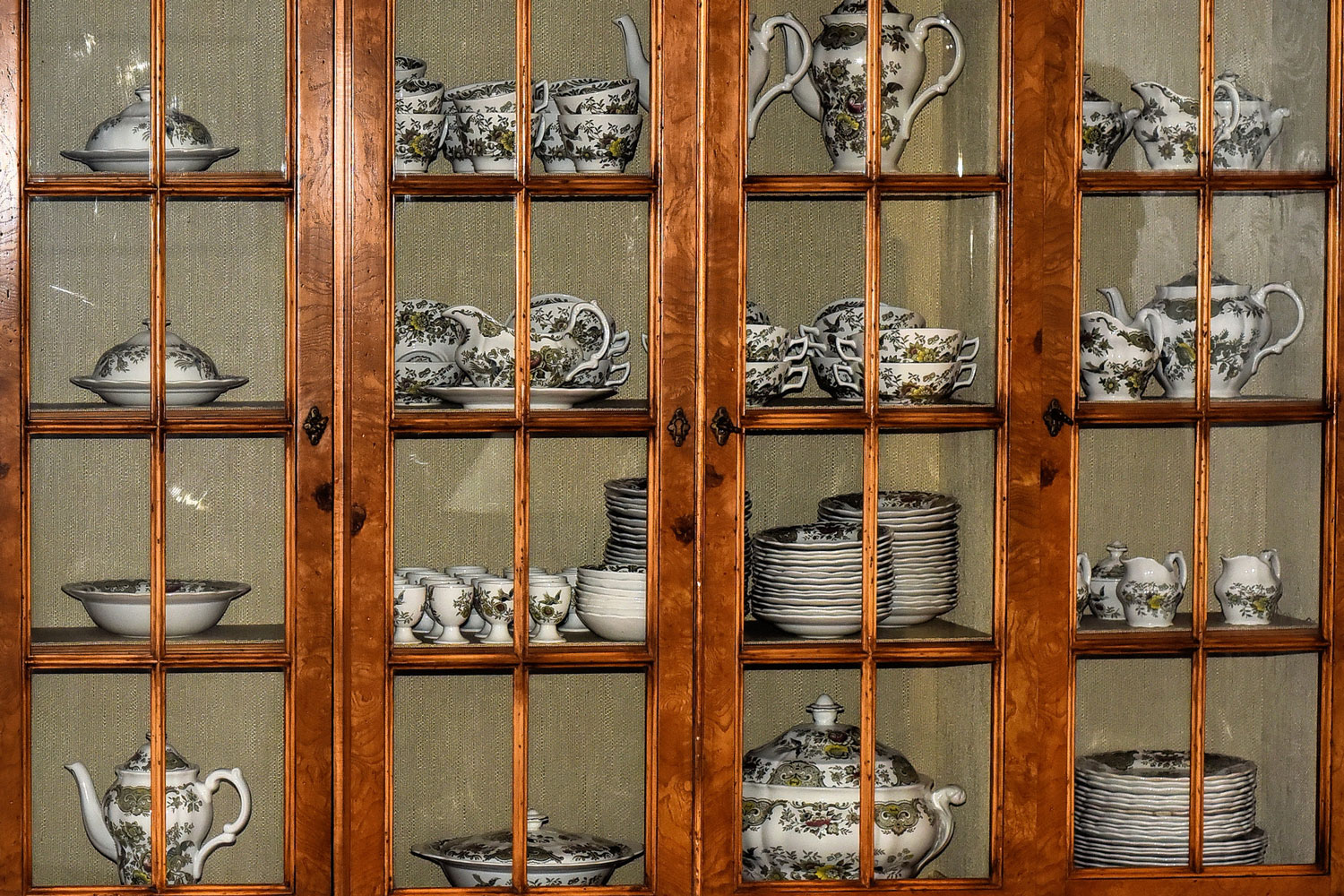 A huge China cabinet filled with China utensils