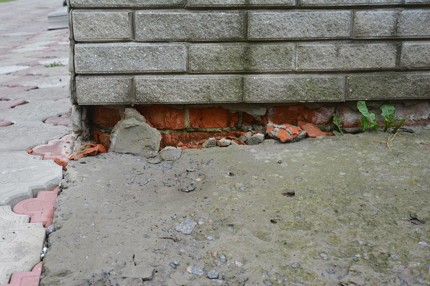 Broken foundation house brick wall