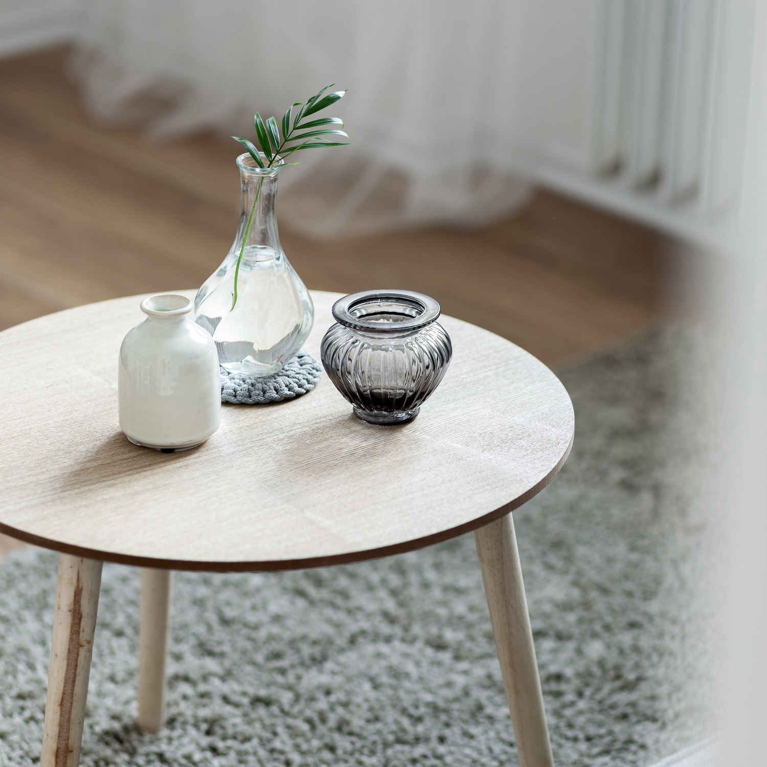 Home interior with scandinavian style wooden, round coffee table