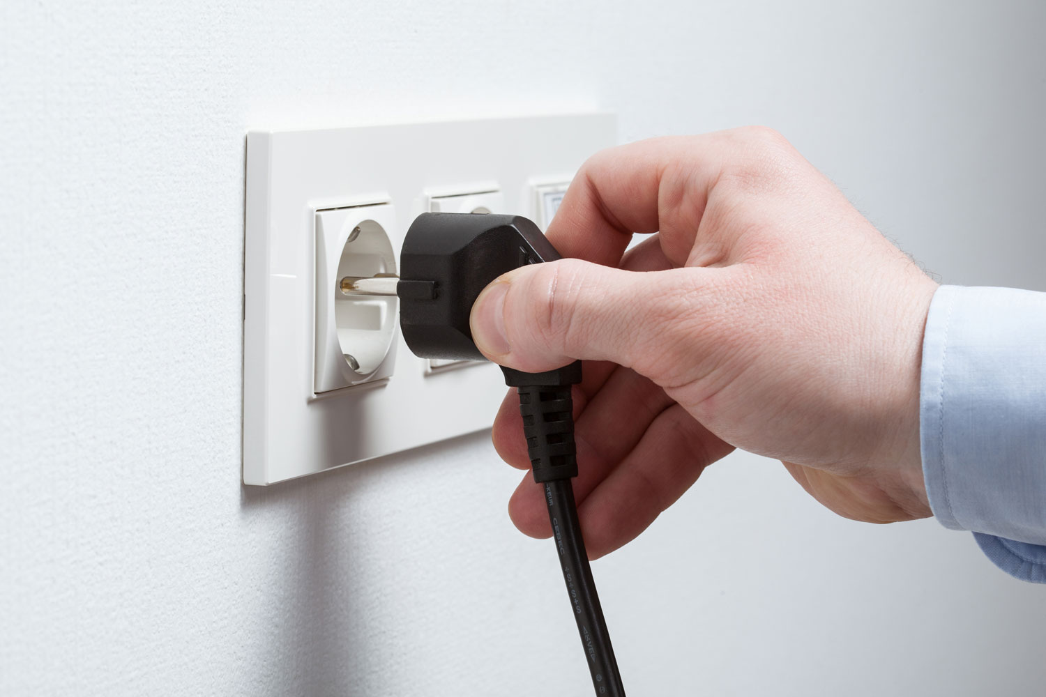 Man inserting a tv plug to the socket