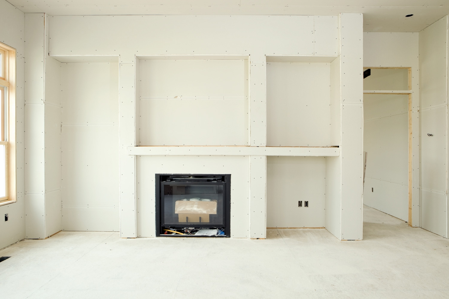 New Living Room Drywall with Fireplace and Built-in Shelves