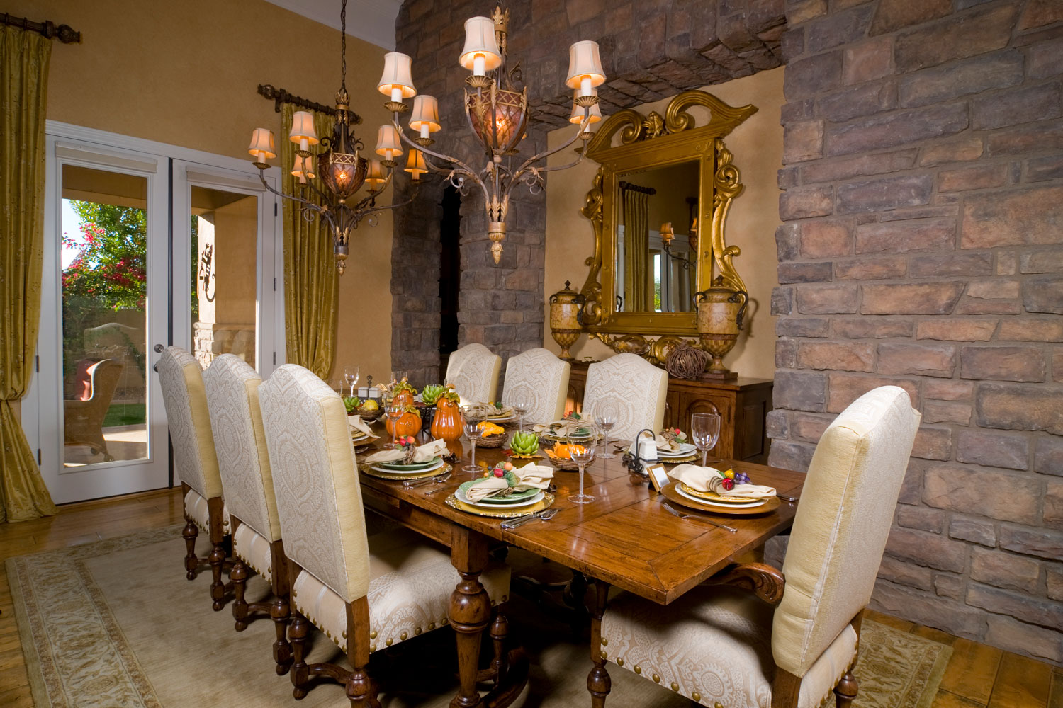 Rustic and mid century inspired dining area with a huge chandelier and wooden tables and cabinets