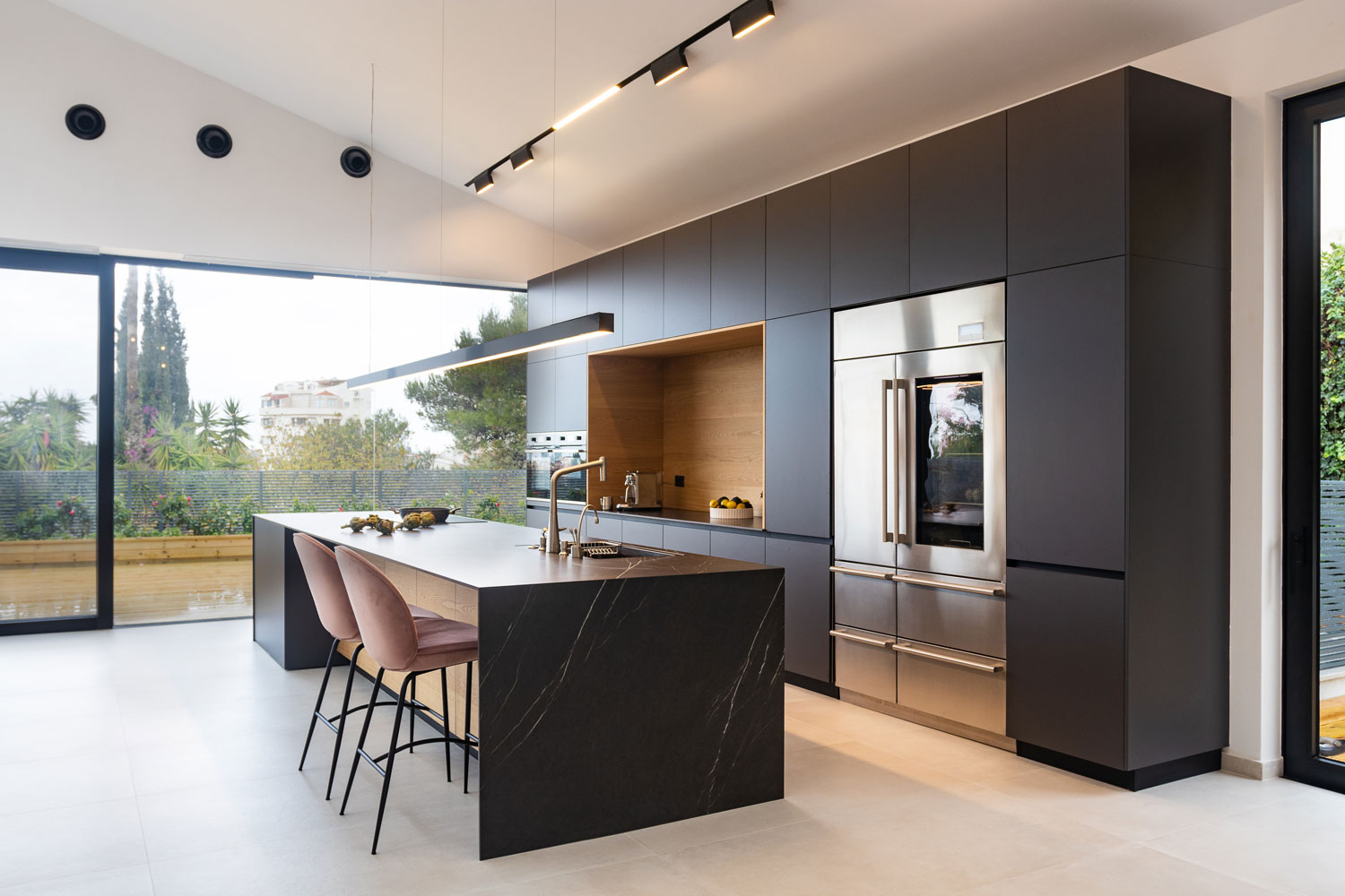 Ultra contemporary inspired kitchen with black granite countertop on the breakfast bar and main kitchen area