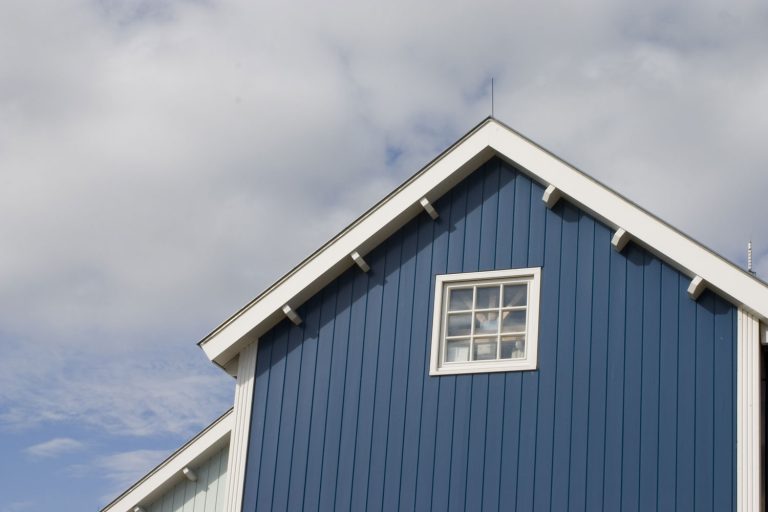 A blue siding farm house with white trims, 9 Great House and Barn Color Combinations