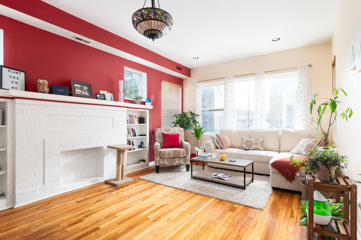 A bright living room with a red accent wall