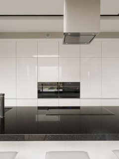 A huge black countertop inside an ultra modern kitchen, 11 Gorgeous Kitchens With Black Worktops