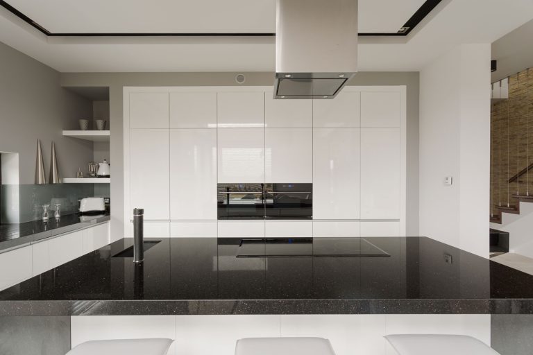 A huge black countertop inside an ultra modern kitchen, 11 Gorgeous Kitchens With Black Worktops