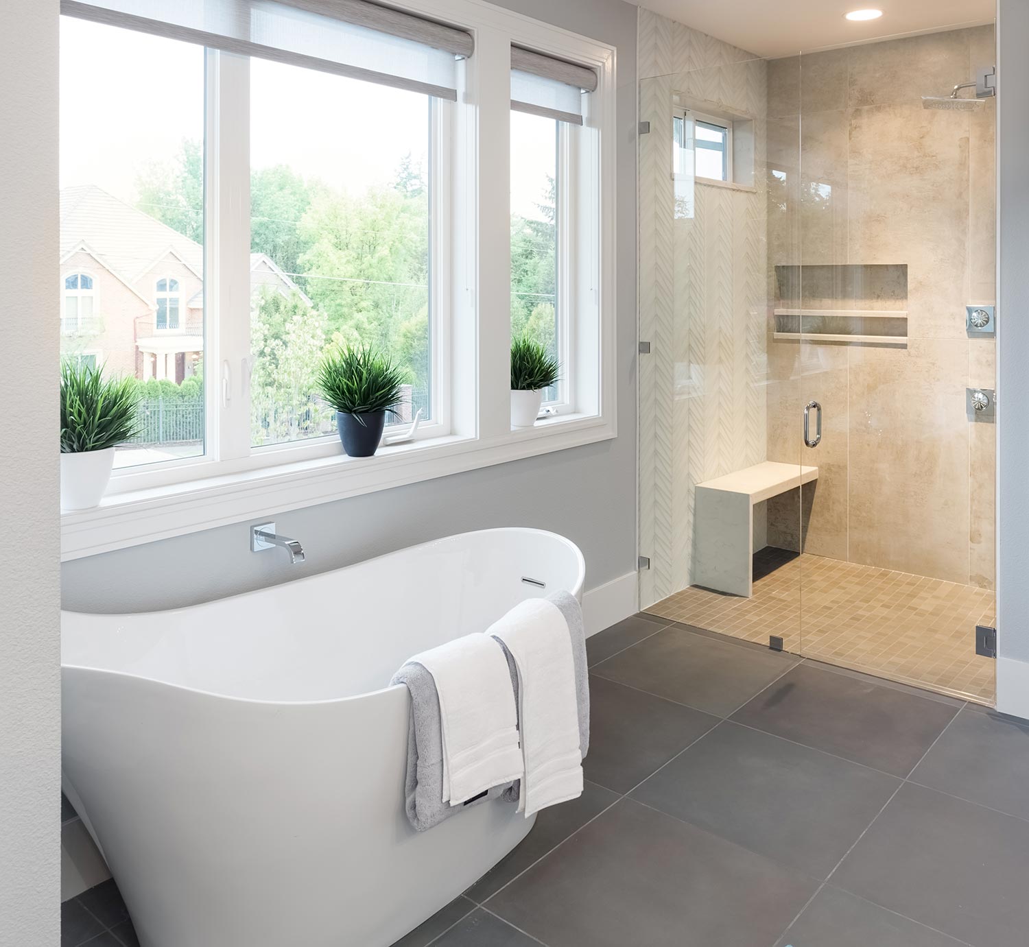 Bathtub and shower in new master bathroom interior in luxury home