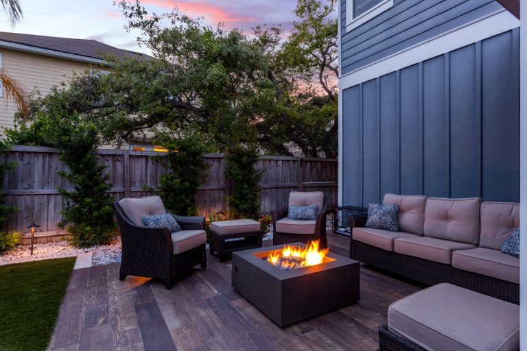 Beautiful backyard firepit at dusk with comfortable chairs, How Much Space Between Fire Pit And Seating?