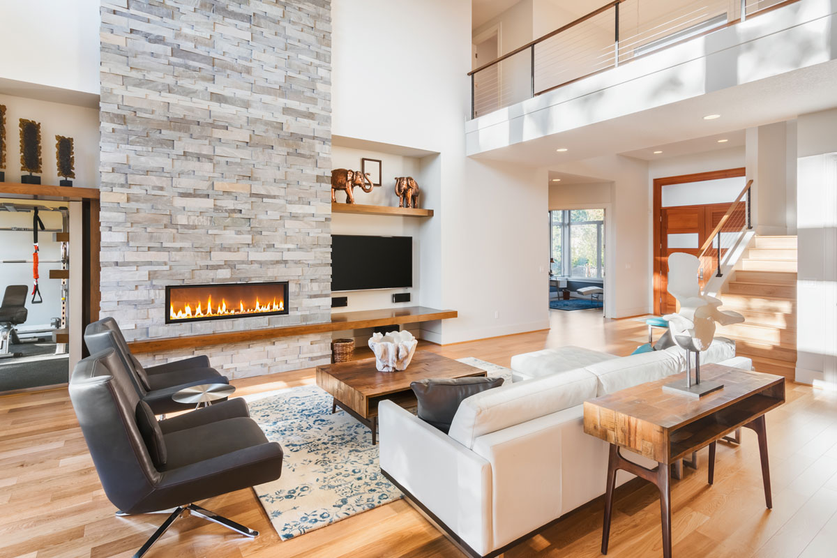 Beautiful living room with hardwood floors and fireplace in new luxury home