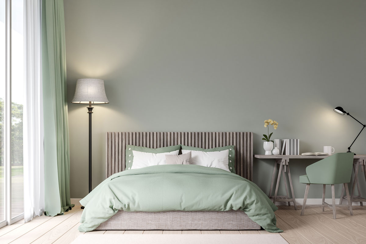 Bedroom with pastel green color and with wooden floors with green fabric furniture