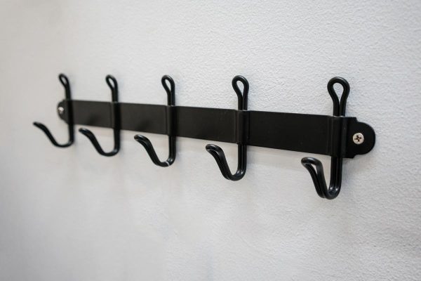 A black metal wall hanger mounted against white wall, Where To Hang Bath Mat To Dry