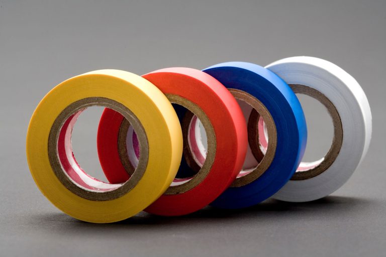 Close-up photo of multiple colored electrical tapes, Does Electrical Tape Stick To Walls? [And Will It Peel Paint Off?]