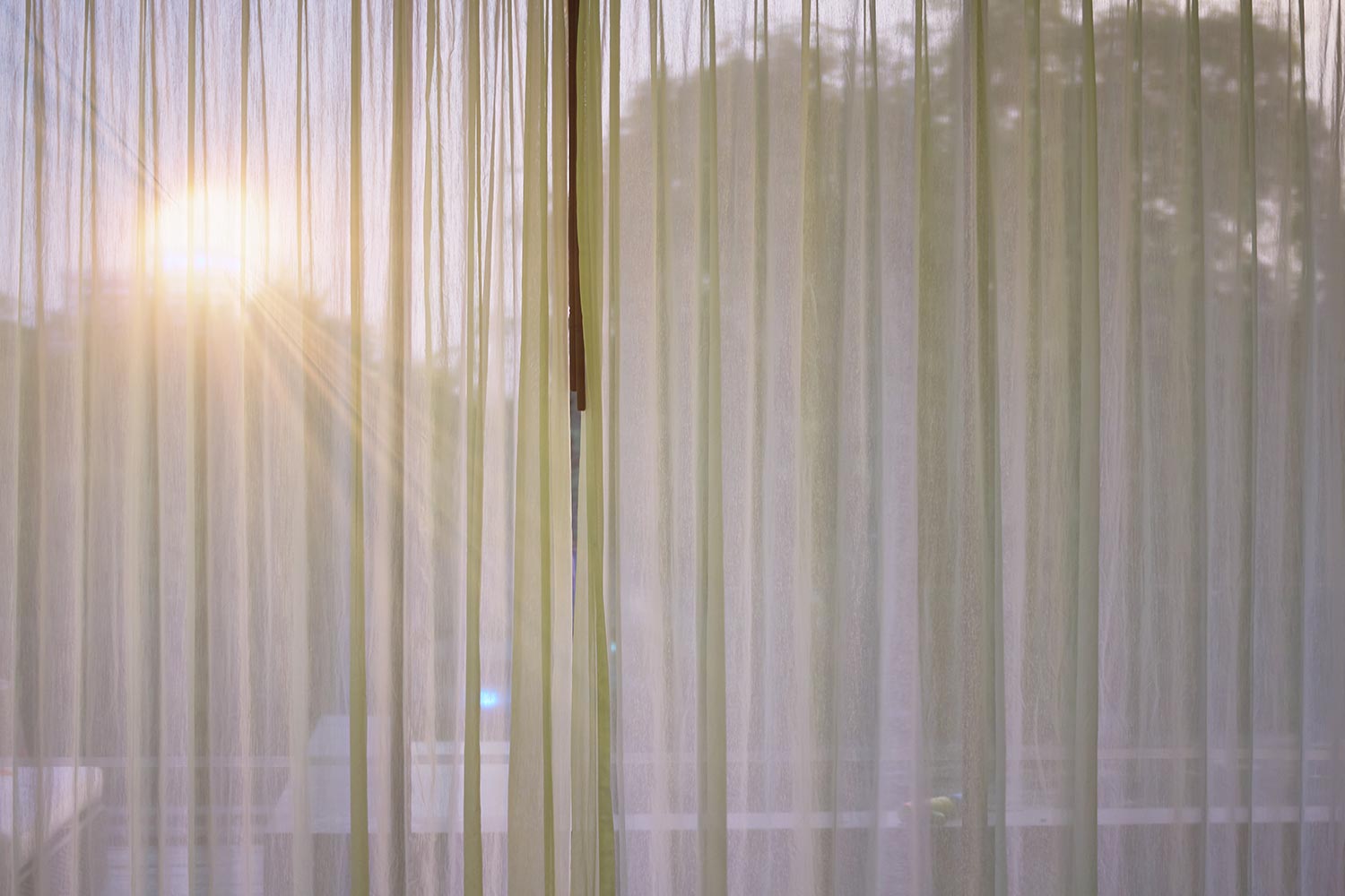 Curtain at window with sun