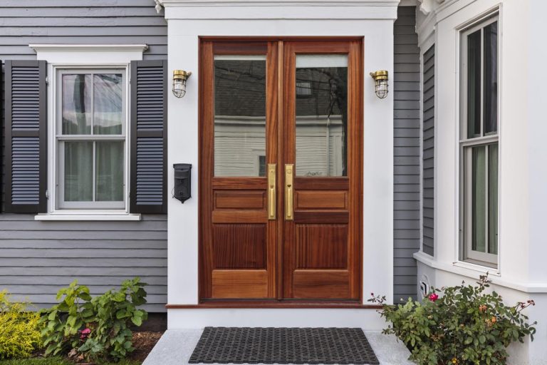 A double brown front door with a secured front entrance, 13 Front Door Window Covering Ideas
