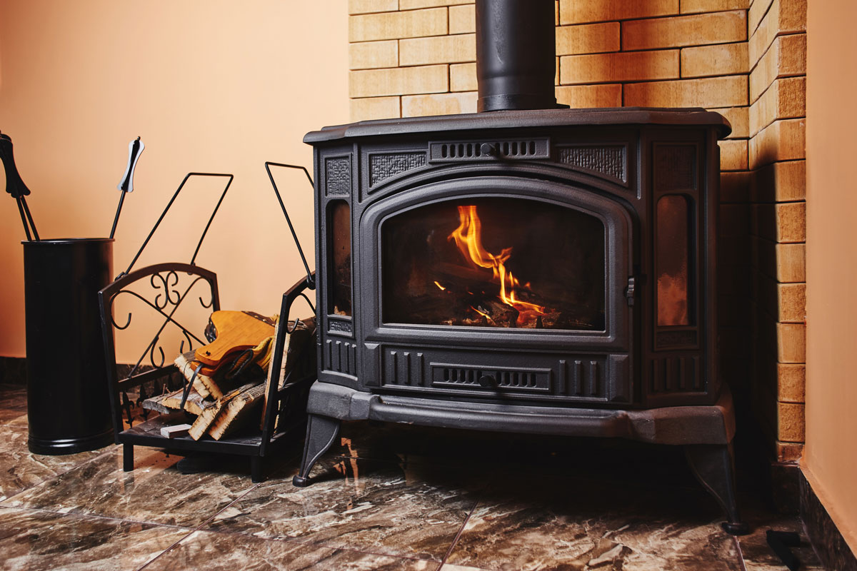 Fireplace and accessories in black with a fire burning inside