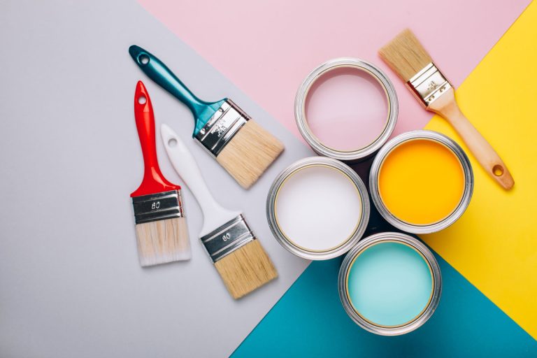 Four open cans of paint with brushes on bright background, Can Sherwin Williams Color Match Benjamin Moore?