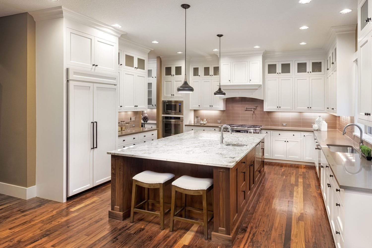 Hardwood flooring inside a classic contemporary inspired kitchen with marble countertop