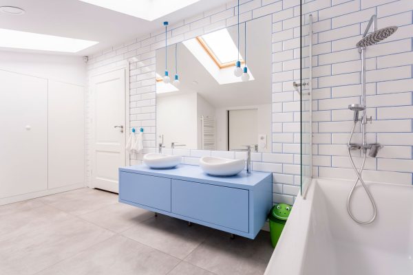 Huge and spacious bright blue and white themed bathroom with a skylight window, What's The Best Window For A Shower? [8 Great Ideas!]