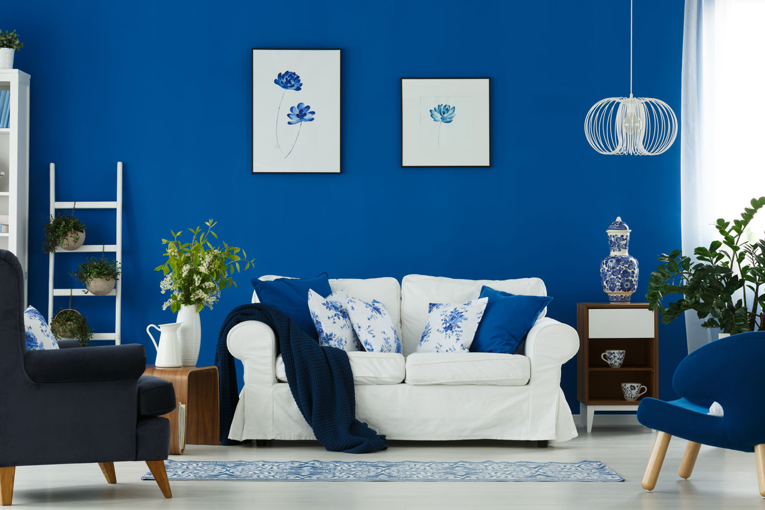 Interior of a blue and white themed living room and incorporated with blue throw pillows