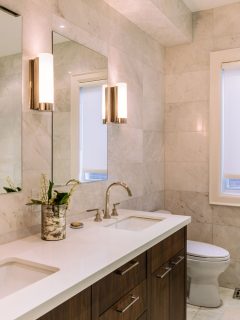 Interior of a gorgeous modern contemporary bathroom with white countertop and gold plated fixtures and wall lamps, How To Repair Spider Cracks In Cultured Marble Sink
