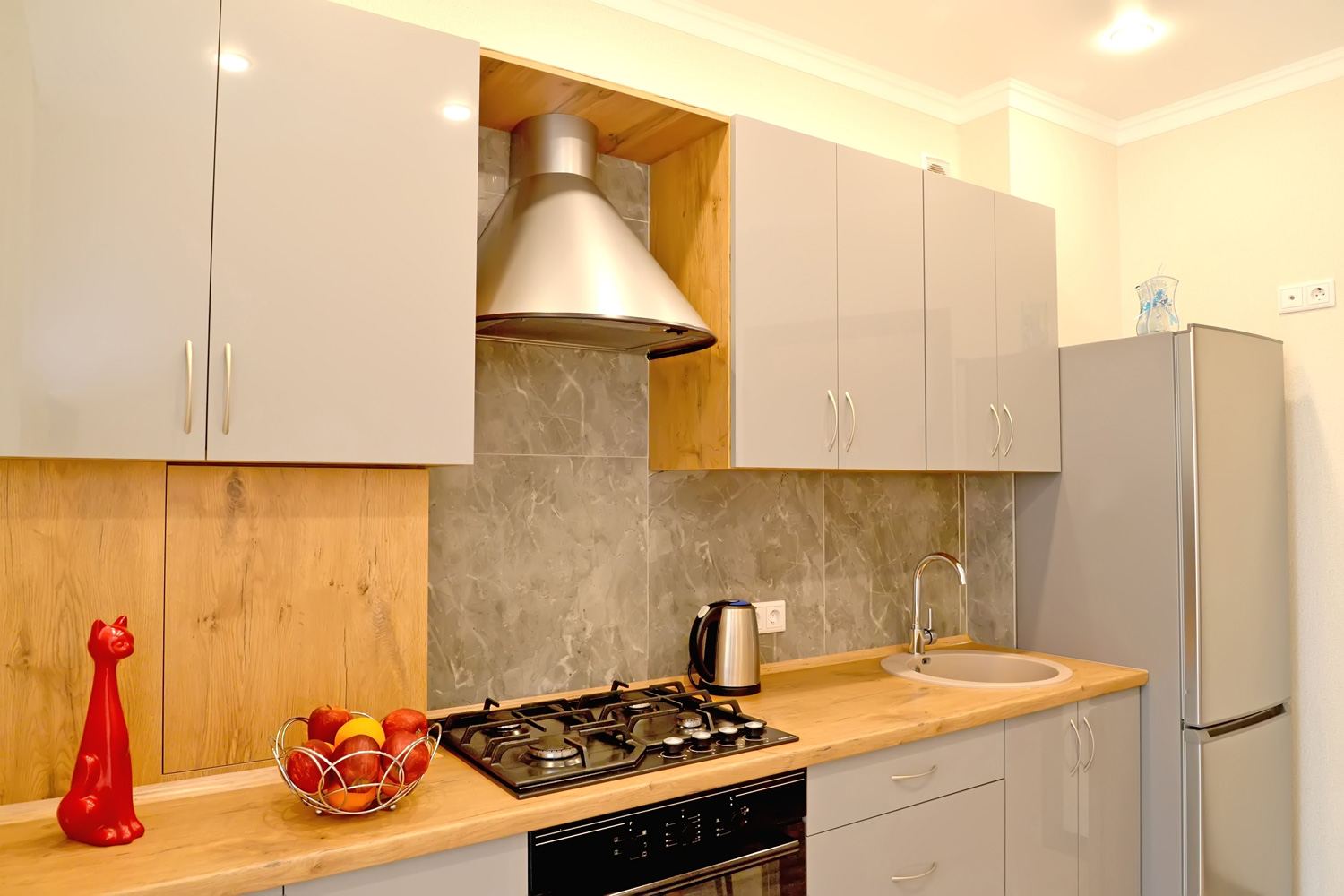 Interior of a modern kitchen with a range hood