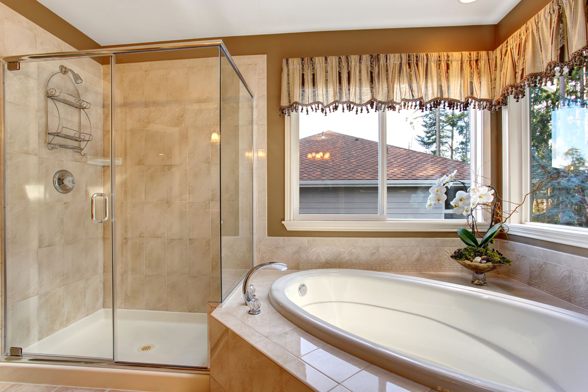 Large elegant master bathroom with shower and big bath tub