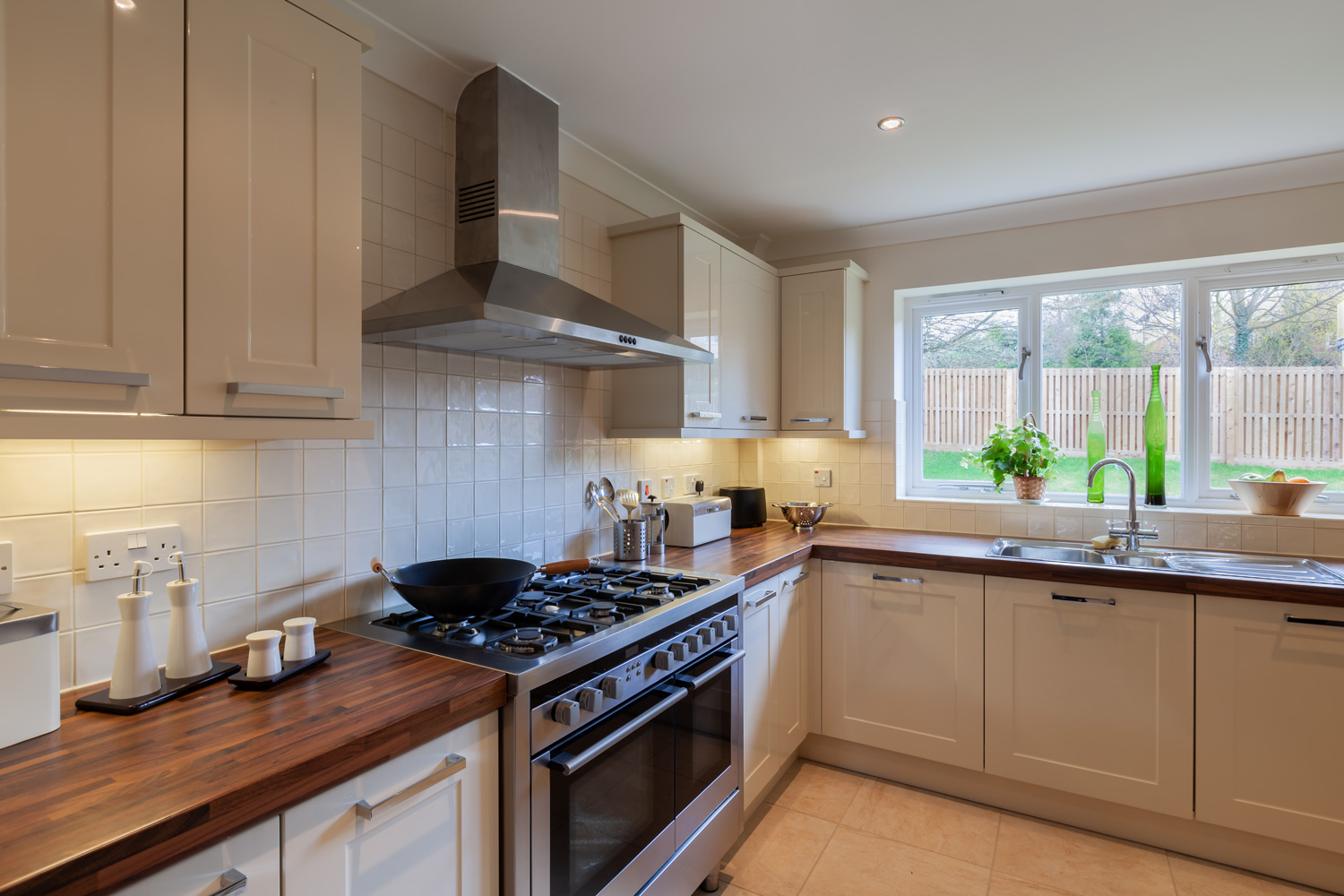 Luxury modern fitted kitchen within new home staged for sale with twin oven stainless steel range