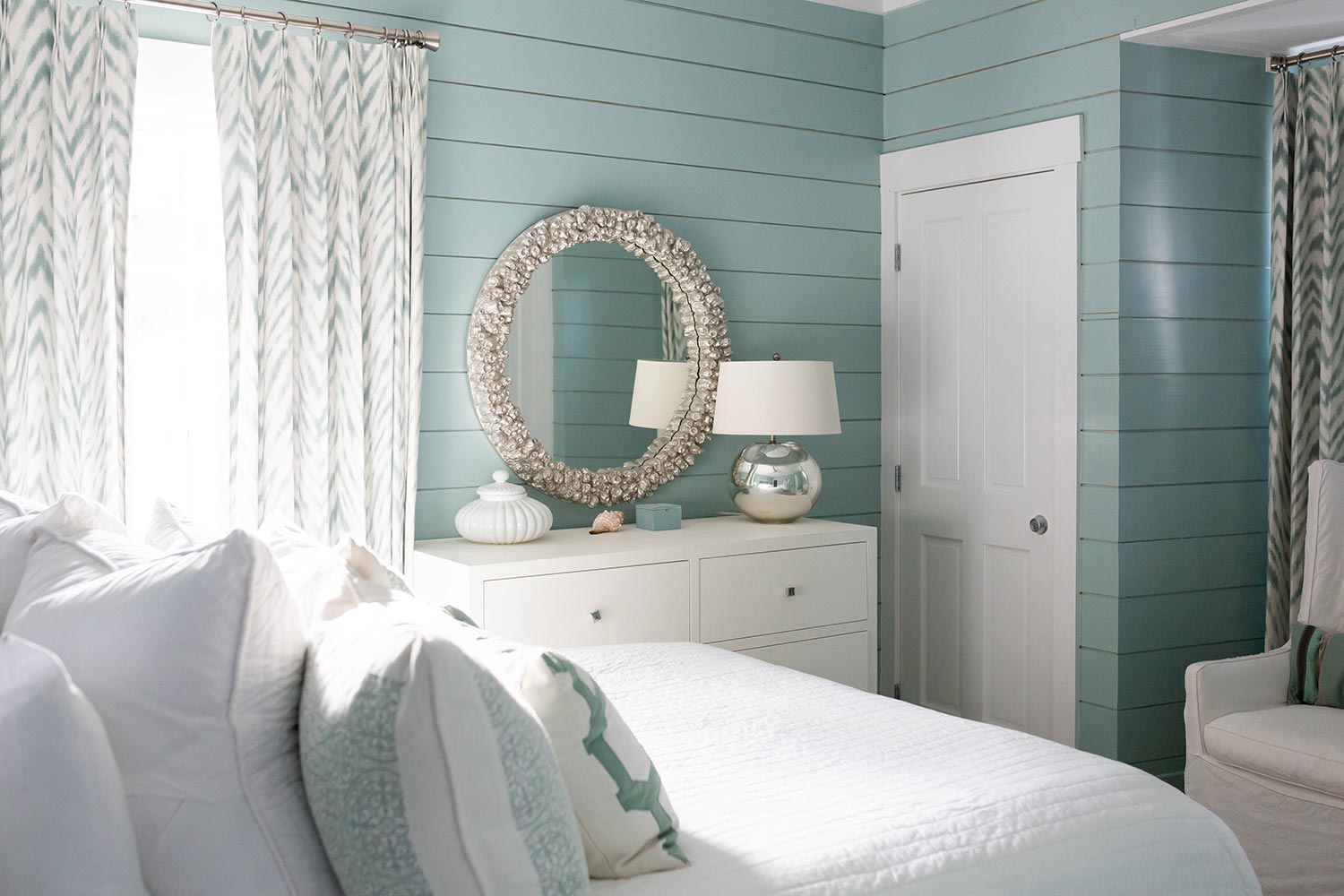 Modern beach house bedroom with teal walls